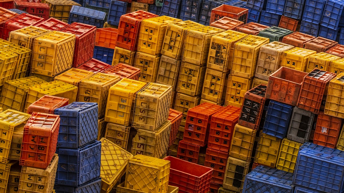 Stacks of coloured plastic crates at a distribution yard | Diwali sale 2026