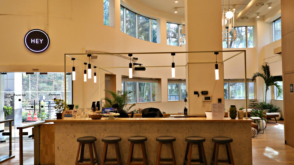 A bright coworking space in India with a coffee bar, stools and plants | Diwali 2026