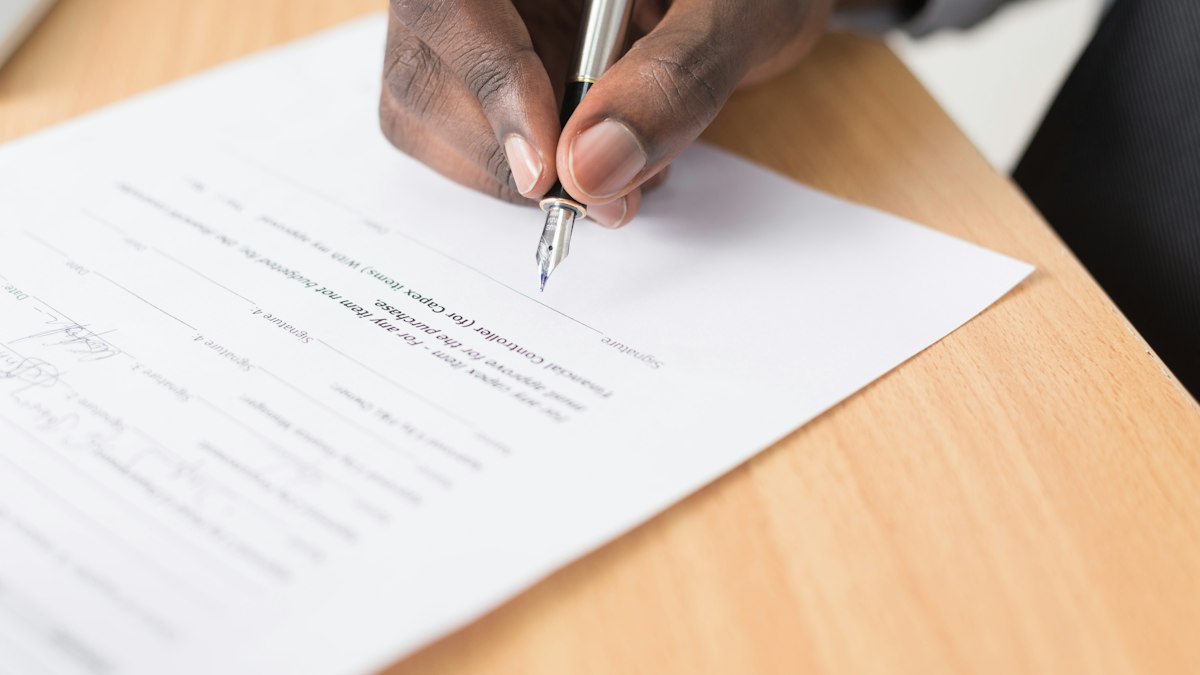 A person writing figures on a printed sheet at a desk | Diwali 2026
