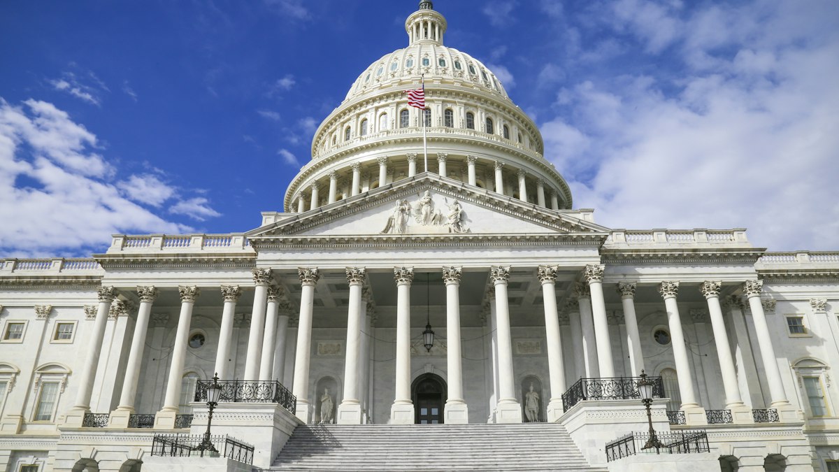 The United States Capitol building with its white dome against a blue sky | GPT-6