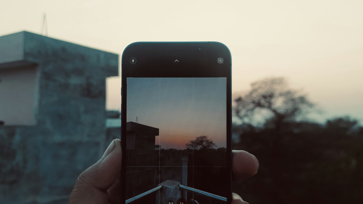 A person photographing a rooftop at dusk with a smartphone in an Indian town | Diwali 2026