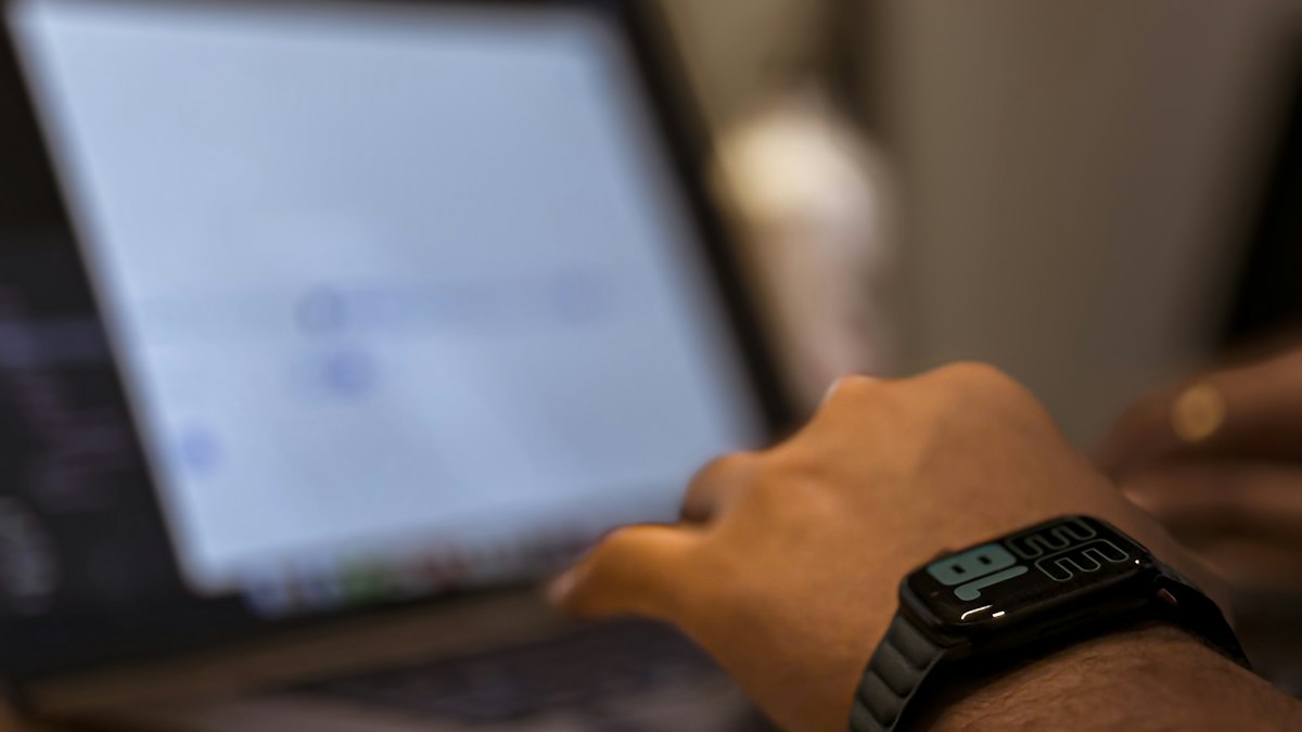 A hand on a laptop running a software dashboard, the kind of online service taxed as OIDAR in India | Opus 5.5