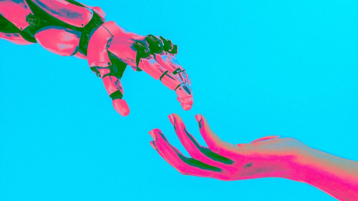 A robot hand reaching towards a human hand